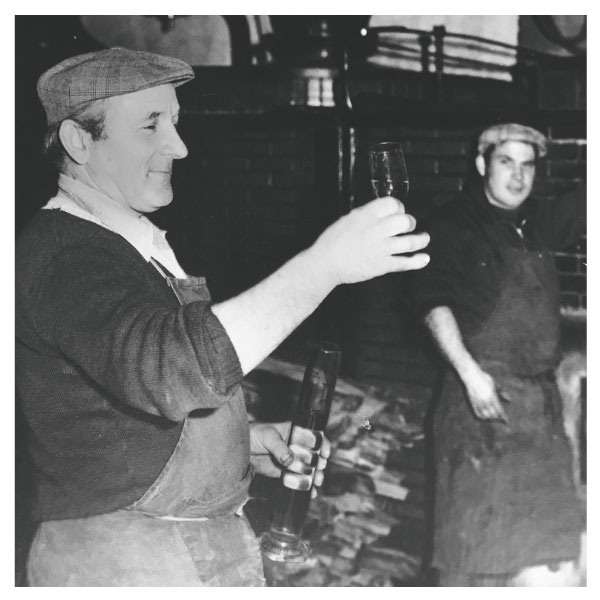 An old photograph of workers in the family winery in Vrbove Slovakia